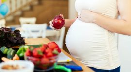 Pregnant woman healthy eating vegetables and fruit